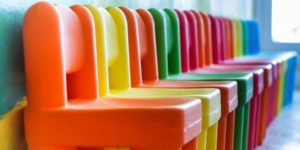 row of bright plastic chairs