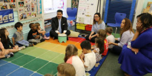 nyc chancellor sitting on floor with young kids