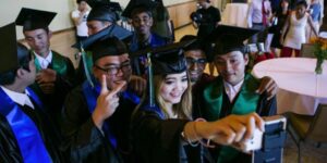 high school graduates wearing cap and gown