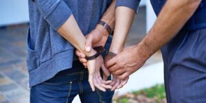 adult handcuffing young person
