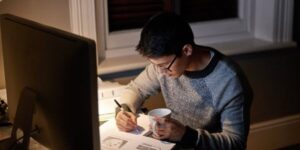 high school student working on homework late at night