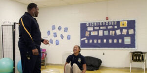 adult talking to student sitting on bean bag