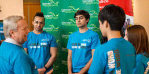 young people wearing blue shirts with slogan spread the word to end the word