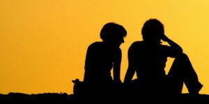 graphic silhouette of two students peers