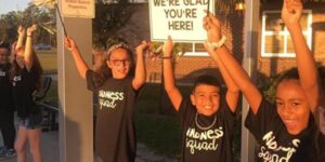 kids holding up kindness signs